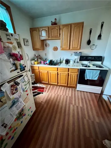 a kitchen with stainless steel appliances granite countertop a stove and a wooden floors