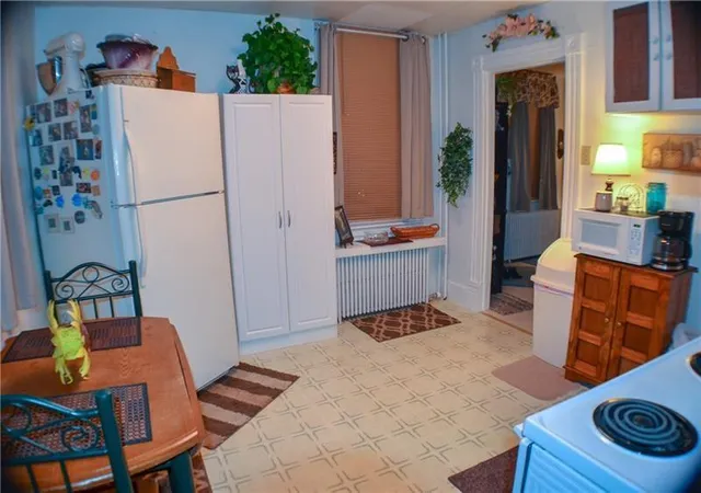 a white refrigerator freezer sitting in a kitchen