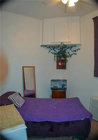 a bedroom with a bed and a chair