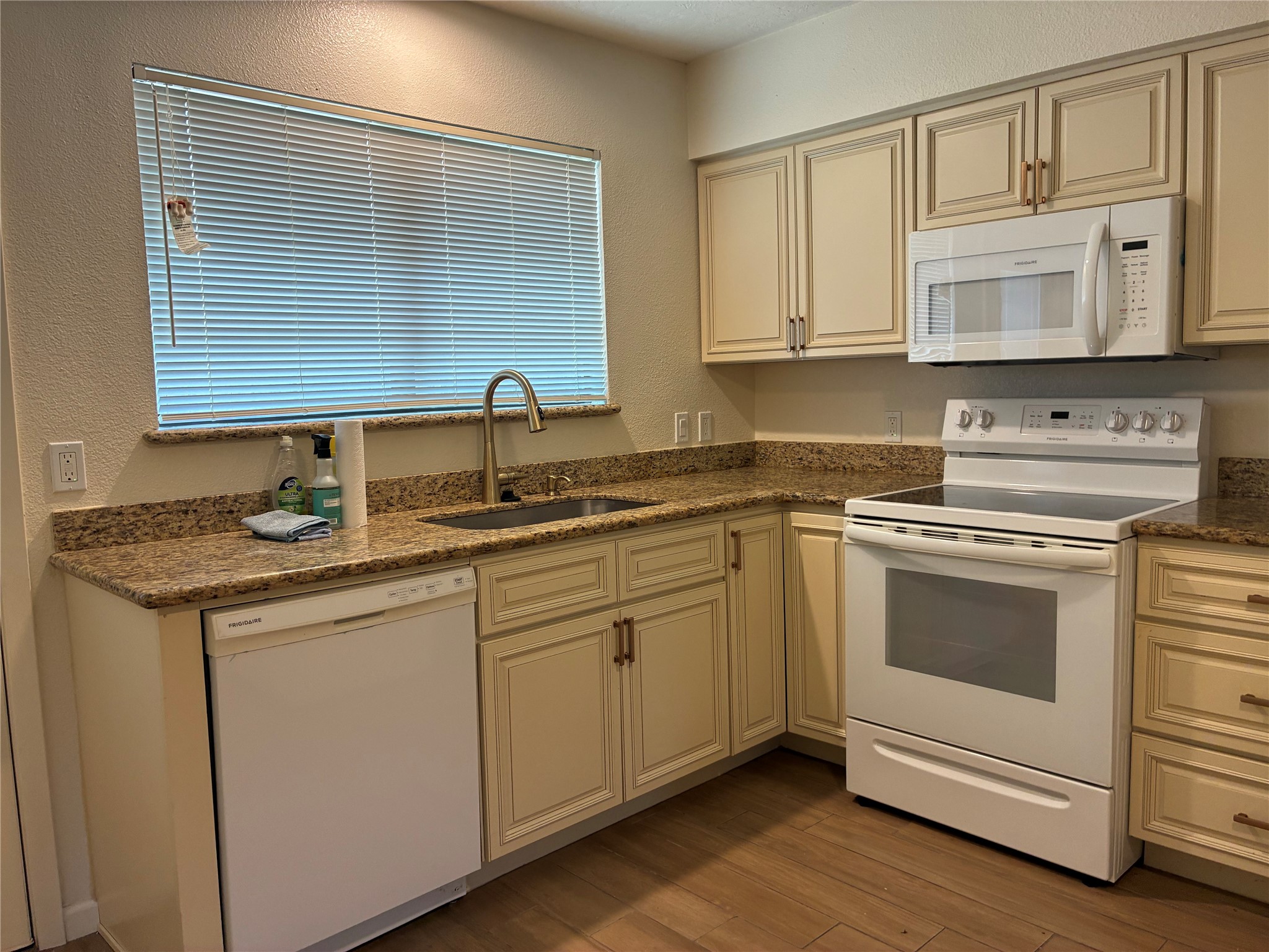6401 Deihl Road, Unit 1011 Houston, TX 77092 - Photo 9 of 16 a kitchen with stainless steel appliances granite countertop a sink and cabinets with wooden floor