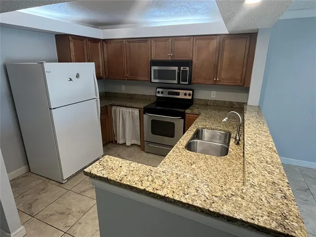 a kitchen with a refrigerator sink and microwave