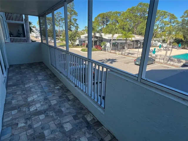 a view of a porch with wooden floor and outdoor space
