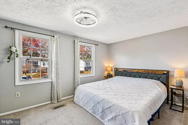 a bedroom with a bed and painting on the wall