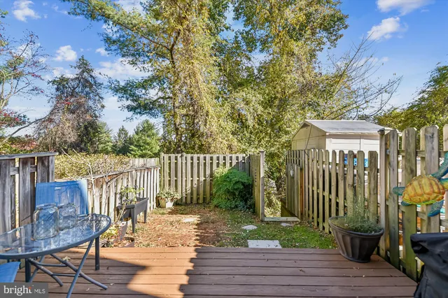 a view of a deck with furniture and wooden fence
