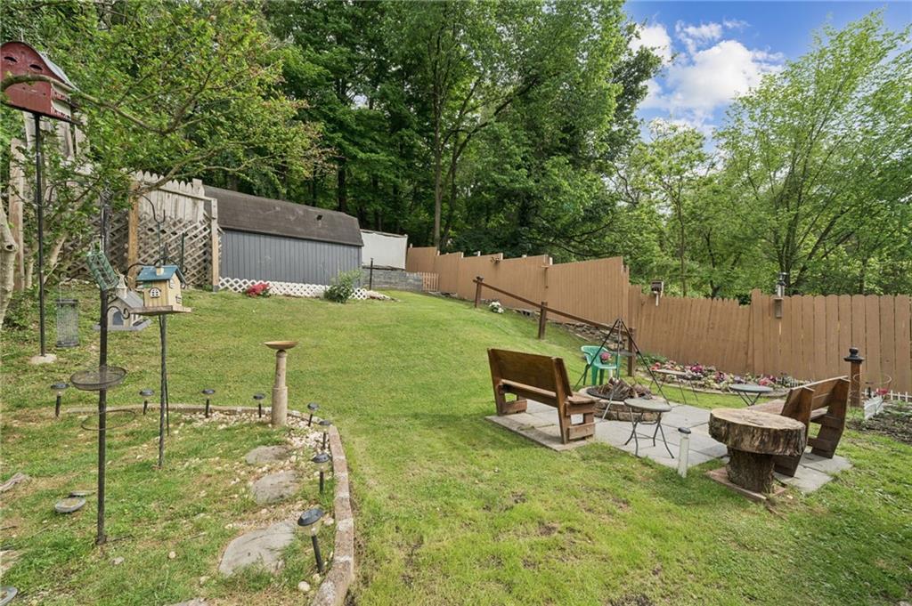 2106 Lindsay Road Pittsburgh, PA 15221 - Photo 33 of 36 The back yard features many garden beds, seating areas, a shed and a movie screen.