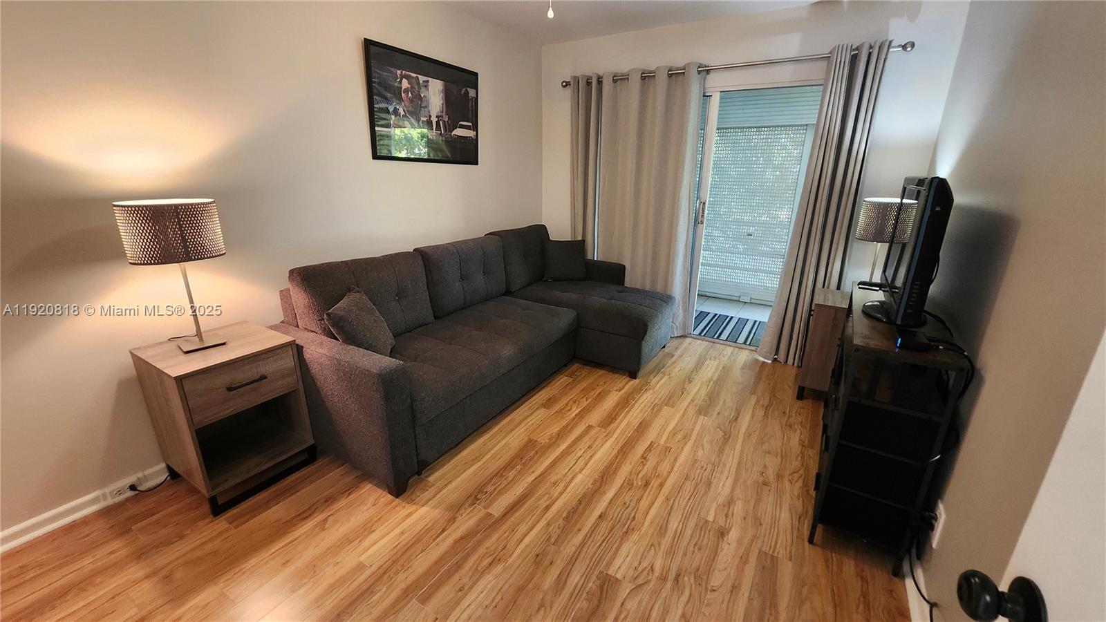 253 Prescott M, Unit 253 Deerfield Beach, FL 33442 - Photo 13 of 53 a living room with furniture a flat screen tv and a fireplace