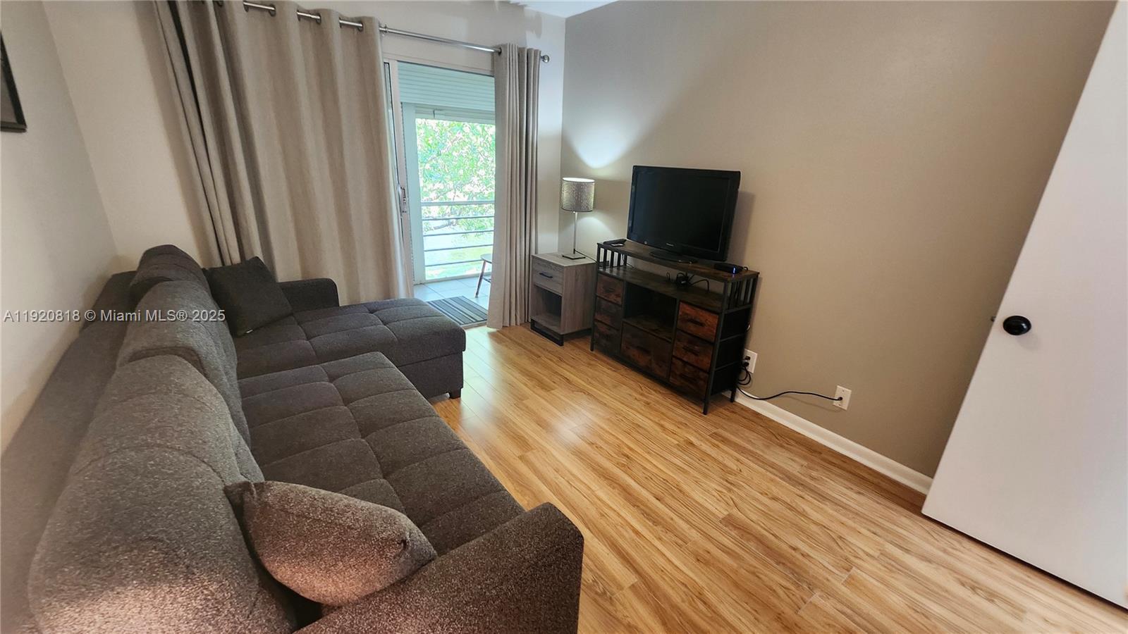 253 Prescott M, Unit 253 Deerfield Beach, FL 33442 - Photo 14 of 53 a living room with furniture and a flat screen tv