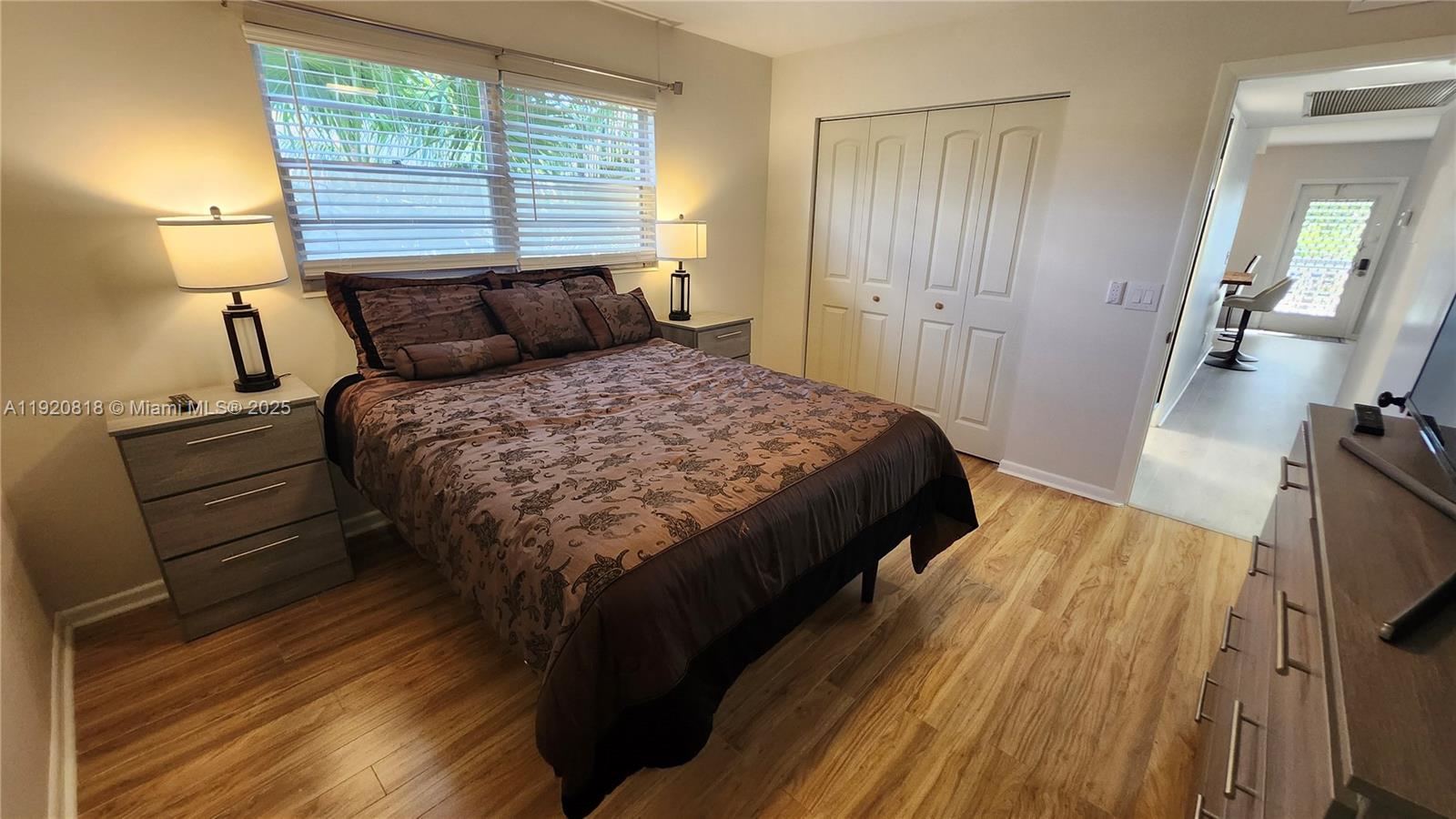 253 Prescott M, Unit 253 Deerfield Beach, FL 33442 - Photo 16 of 53 a bedroom with a bed and wooden floor