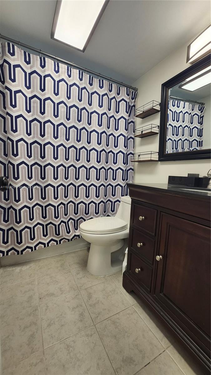 253 Prescott M, Unit 253 Deerfield Beach, FL 33442 - Photo 18 of 53 a bathroom with a granite countertop toilet and sink