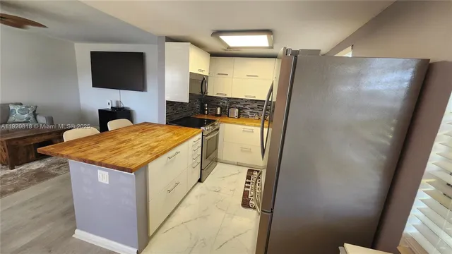 a kitchen with a sink a stove and cabinets