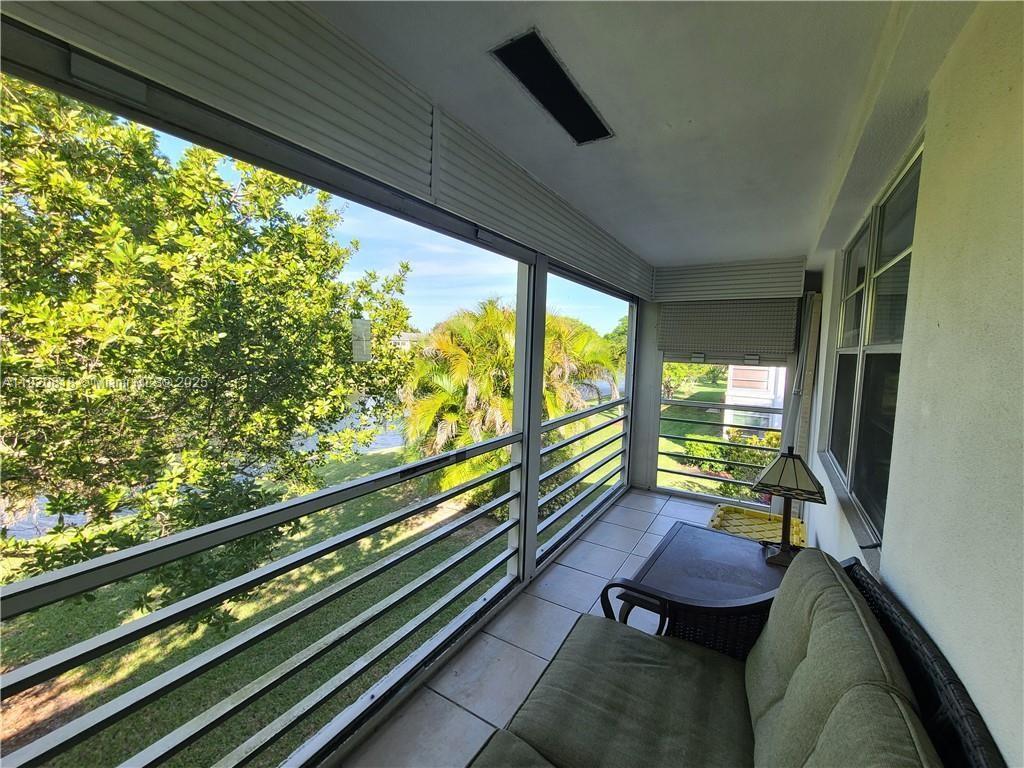 253 Prescott M, Unit 253 Deerfield Beach, FL 33442 - Photo 22 of 53 a view of two chairs in the balcony