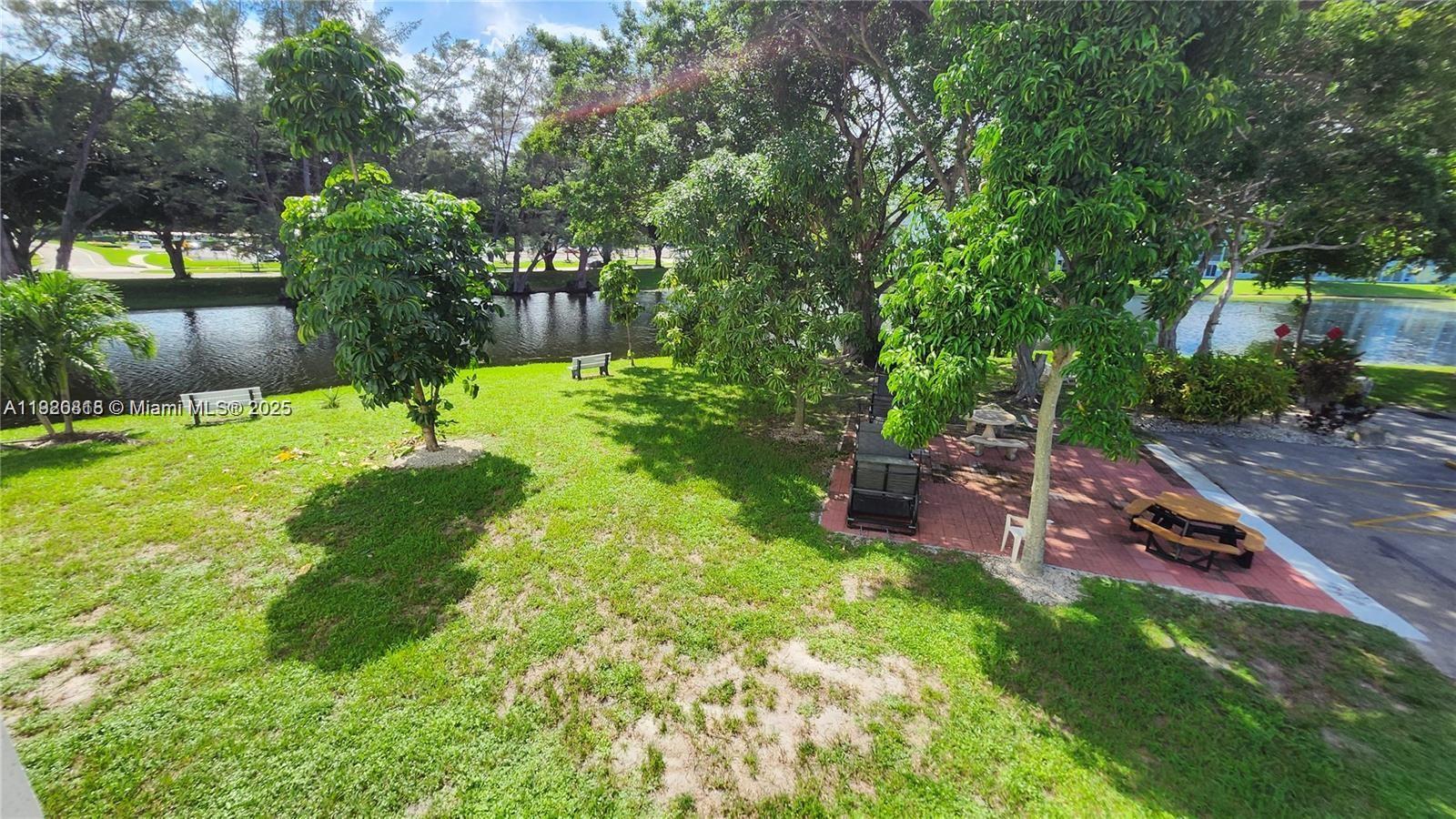 253 Prescott M, Unit 253 Deerfield Beach, FL 33442 - Photo 44 of 53 a view of a backyard with plants and a patio