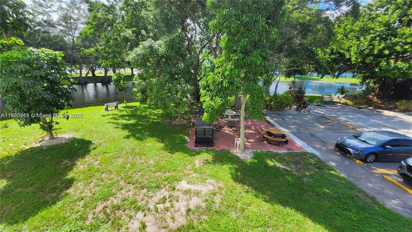 253 Prescott M, Unit 253 Deerfield Beach, FL 33442 - Photo 45 of 53 a garden view with a seating space