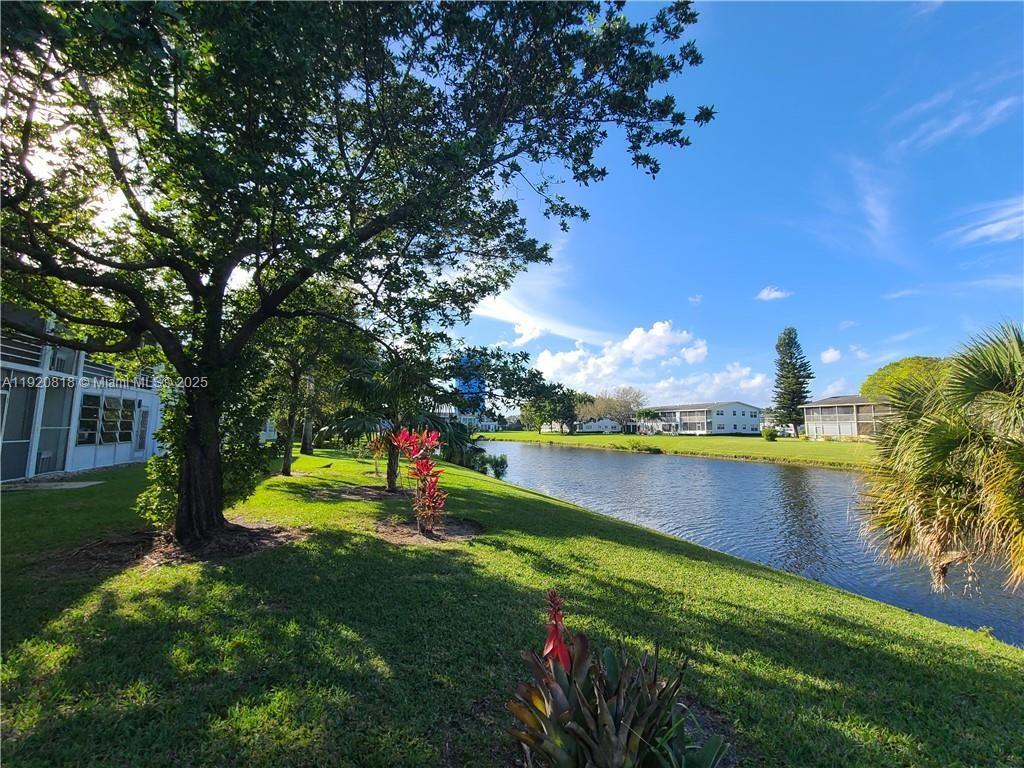 253 Prescott M, Unit 253 Deerfield Beach, FL 33442 - Photo 48 of 53 a view of a lake with houses in the back