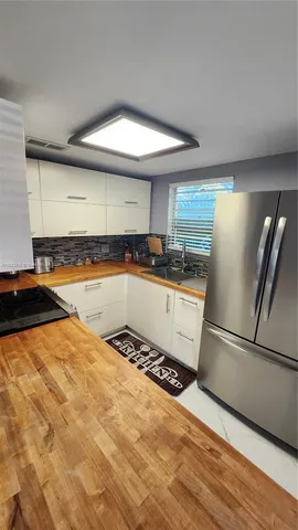 a kitchen with a sink a stove and cabinets