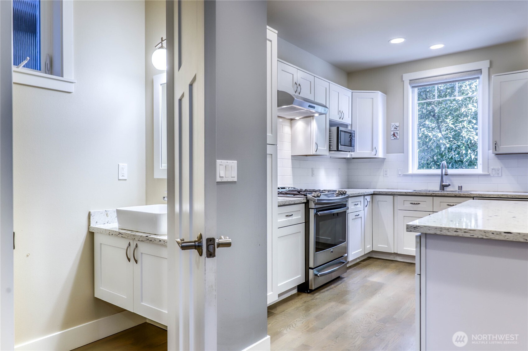 690 Wintersweet Road Northeast Bainbridge Island, WA 98110 - Photo 8 of 23 a kitchen with cabinets appliances and a window