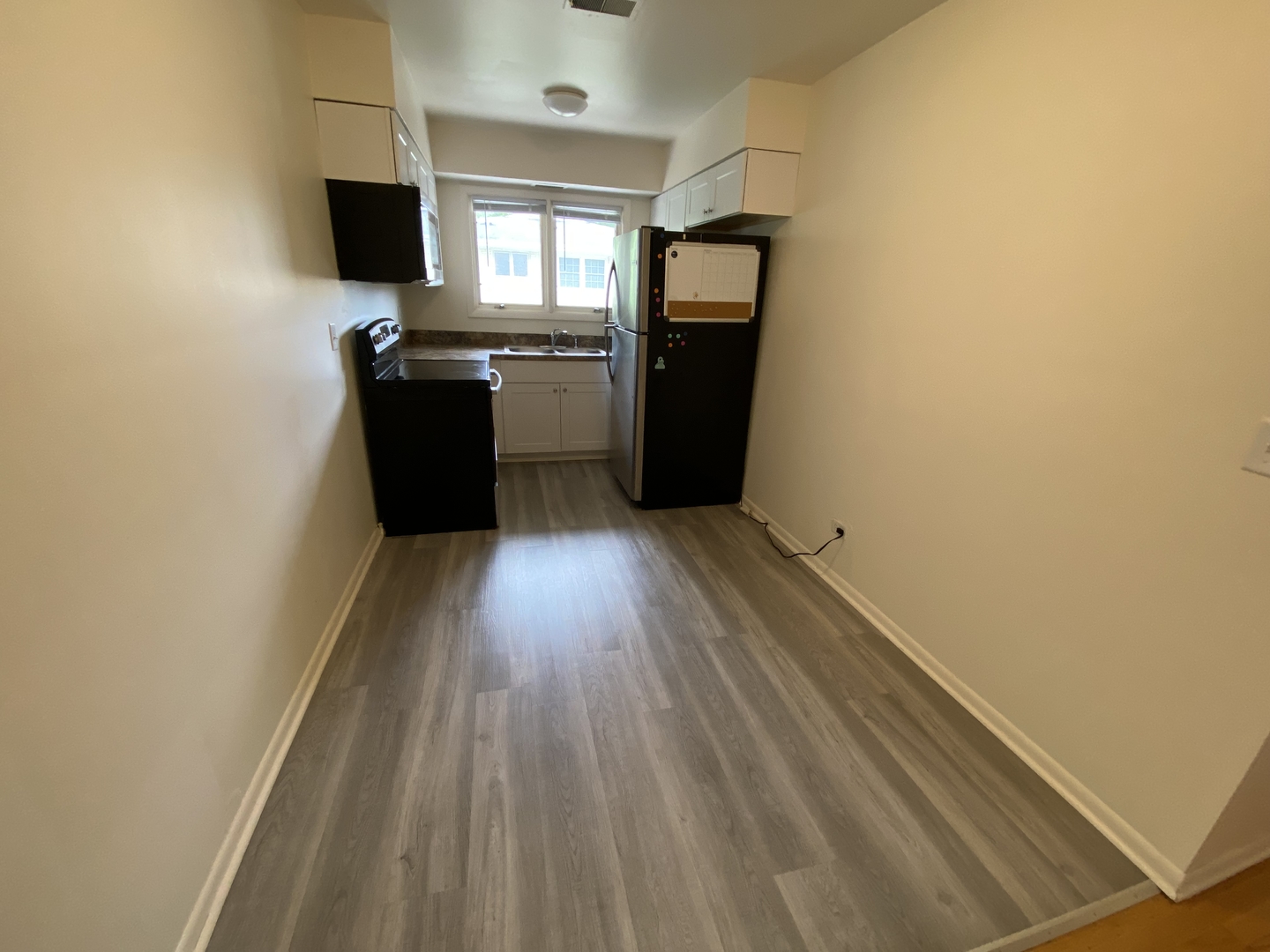 518 Anderson Boulevard, Unit 2S Geneva, IL 60134 - Photo 3 of 8 a kitchen with a refrigerator and a stove top oven