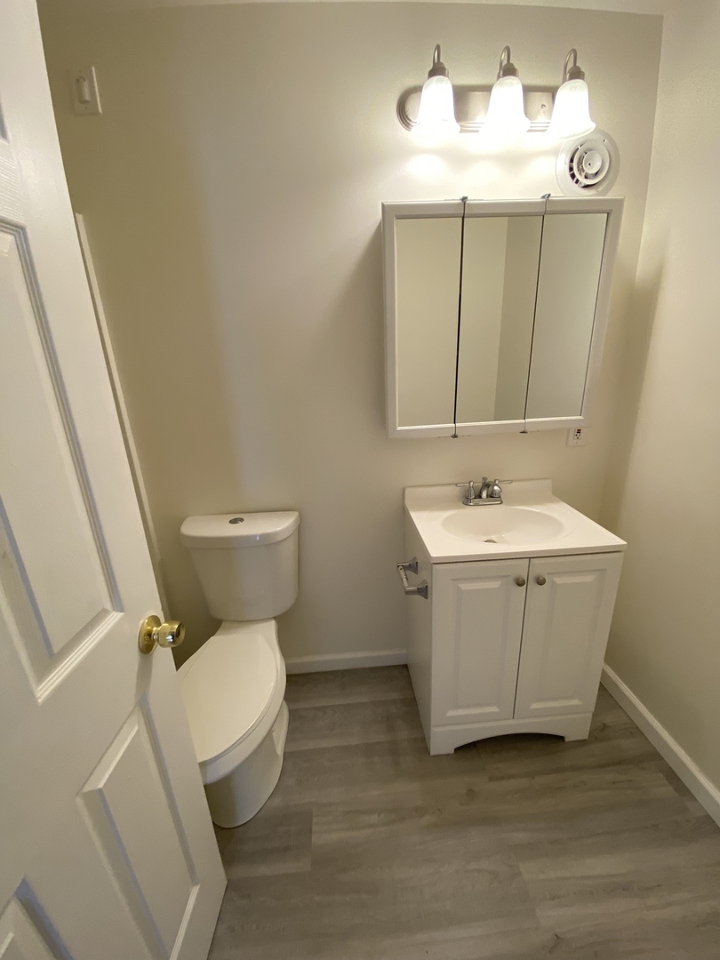 518 Anderson Boulevard, Unit 2S Geneva, IL 60134 - Photo 4 of 8 a bathroom with a sink mirror vanity and toilet