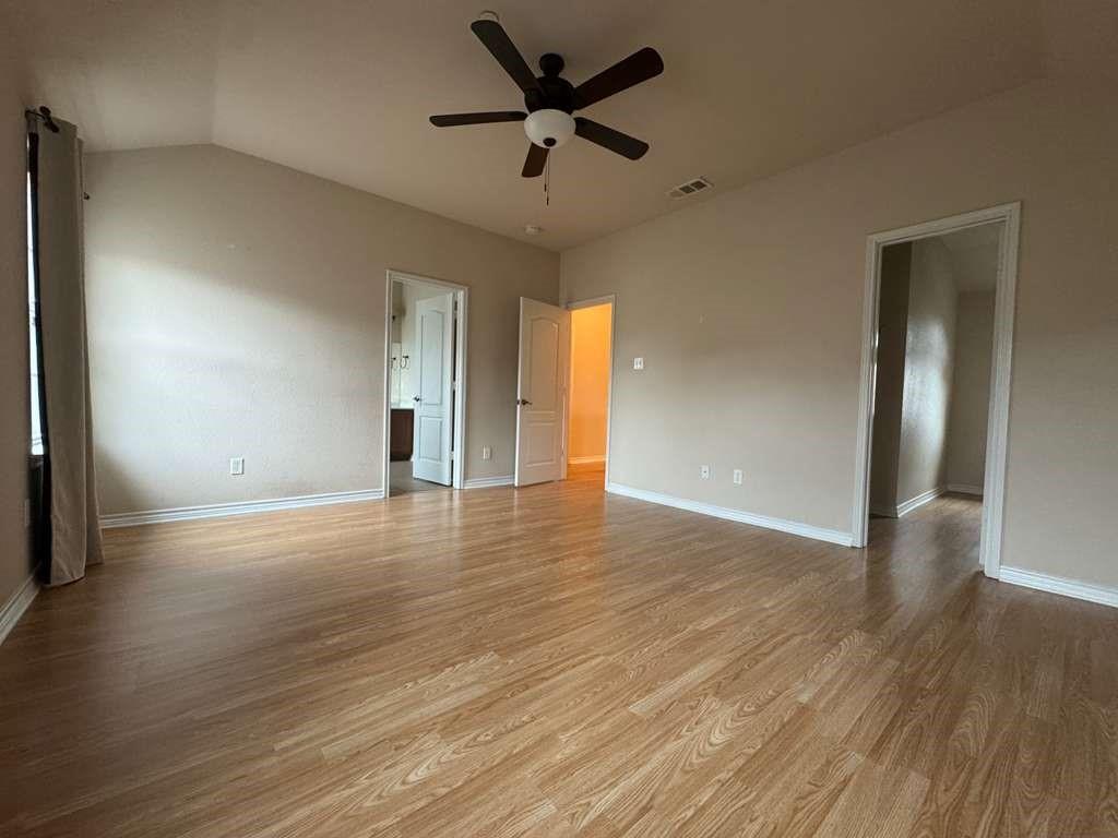 5820 Stone Mountain Road The Colony, TX 75056 - Photo 11 of 27 a view of an empty room with wooden floor and a ceiling fan