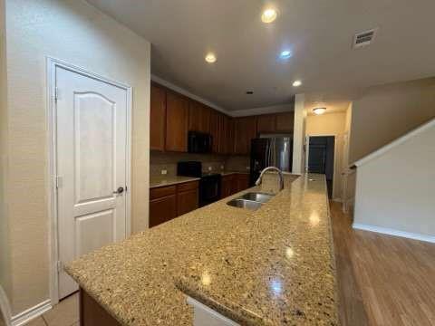 5820 Stone Mountain Road The Colony, TX 75056 - Photo 13 of 27 a kitchen with a refrigerator and a sink