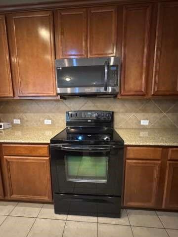 5820 Stone Mountain Road The Colony, TX 75056 - Photo 15 of 27 a kitchen with a stove and a microwave