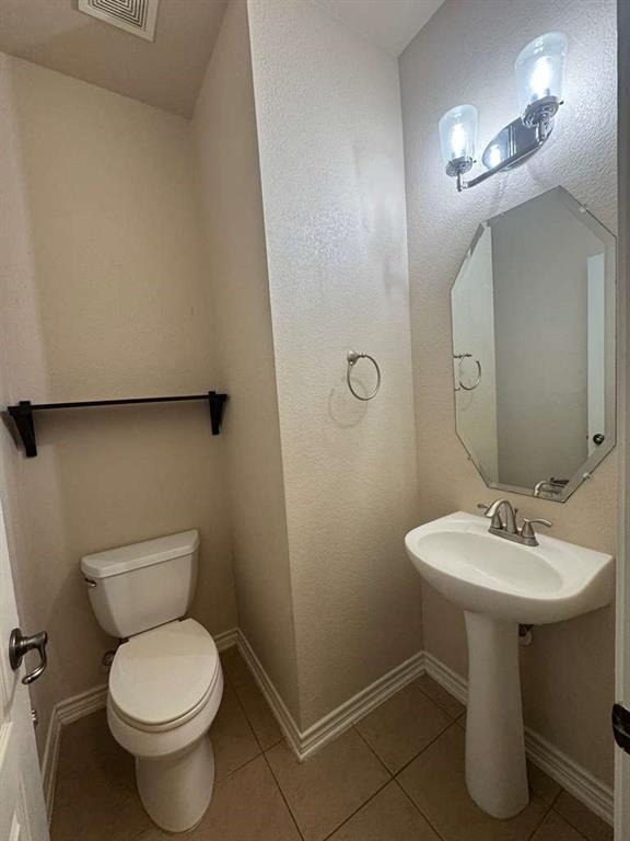 5820 Stone Mountain Road The Colony, TX 75056 - Photo 16 of 27 a bathroom with a toilet sink and mirror