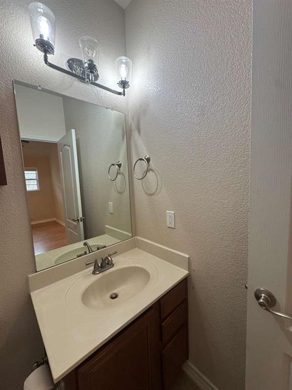 5820 Stone Mountain Road The Colony, TX 75056 - Photo 17 of 27 a bathroom with a sink and a mirror