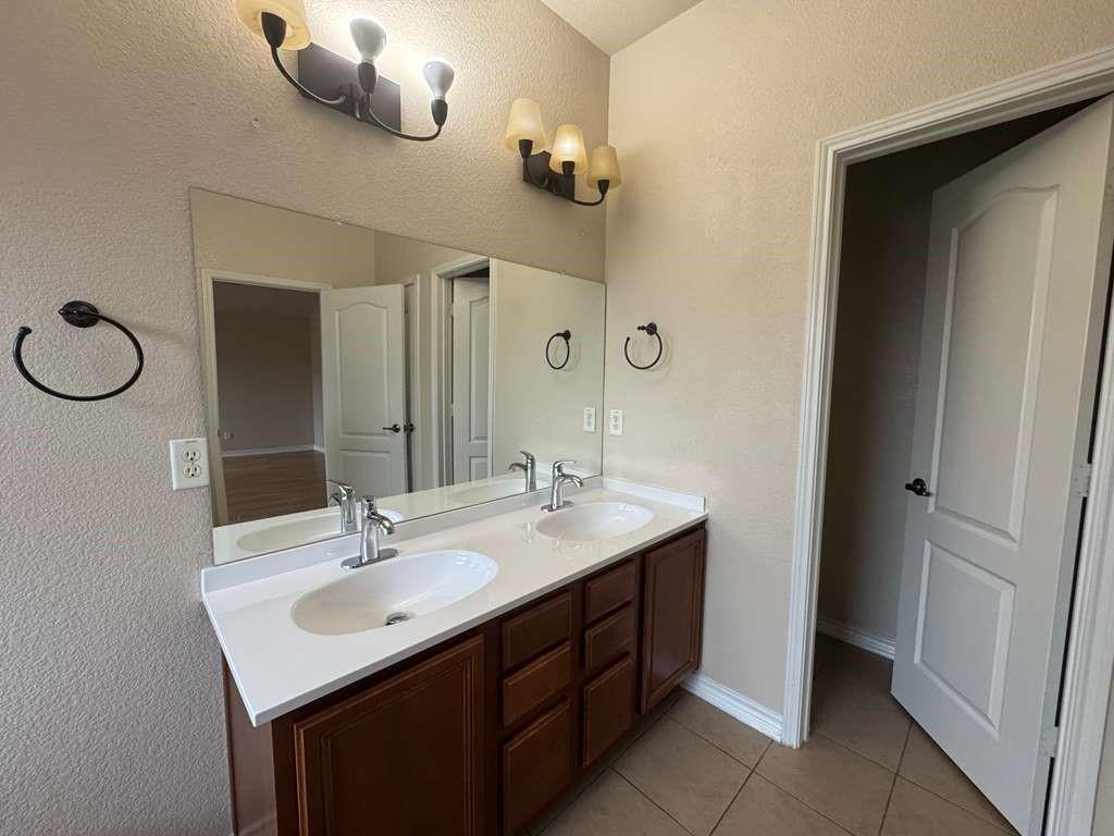 5820 Stone Mountain Road The Colony, TX 75056 - Photo 21 of 27 a bathroom with a sink and a mirror
