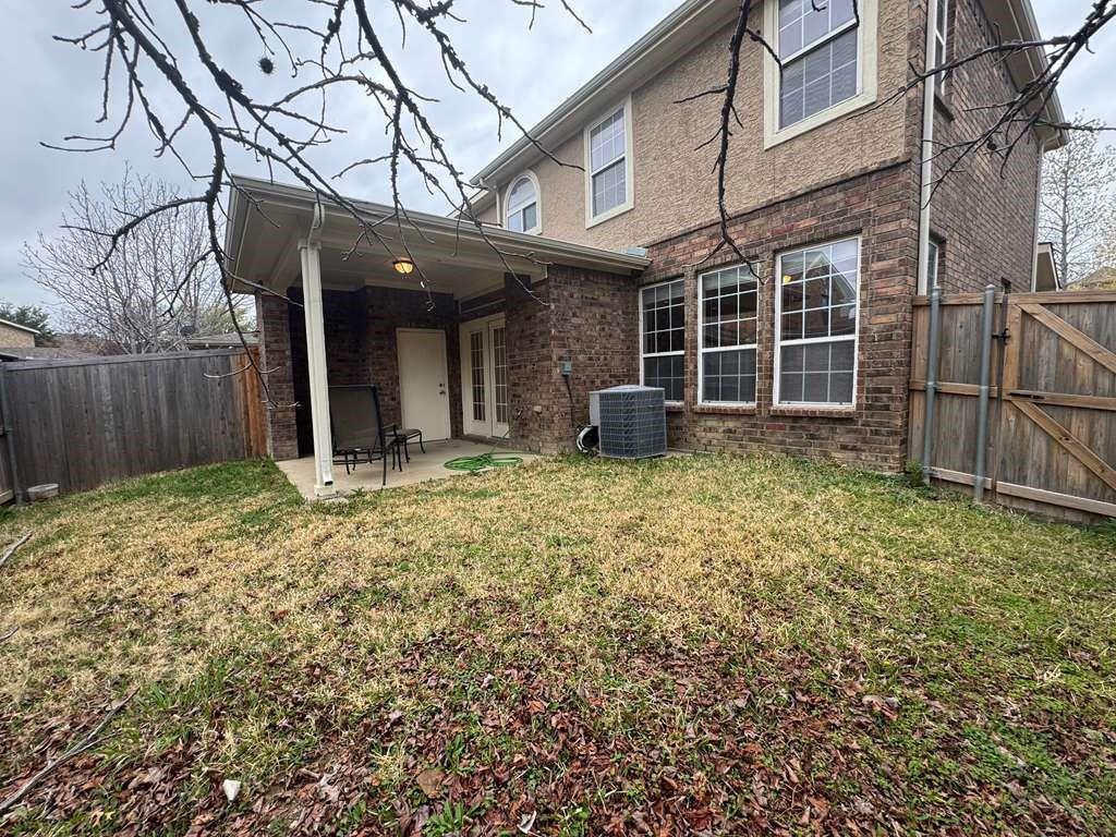 5820 Stone Mountain Road The Colony, TX 75056 - Photo 25 of 27 a view of a house with a yard and wooden fence