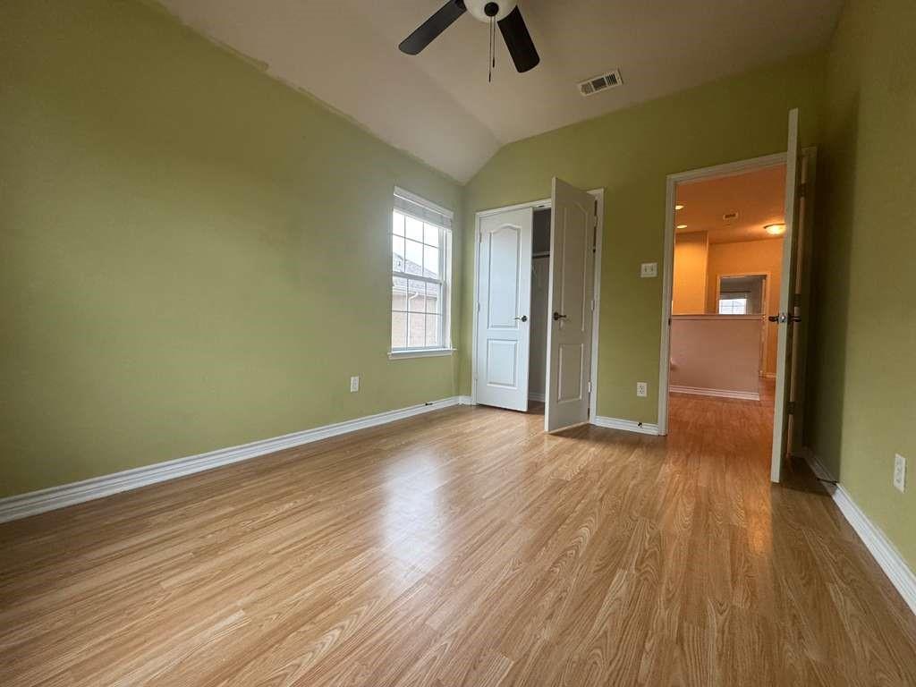 5820 Stone Mountain Road The Colony, TX 75056 - Photo 10 of 27 wooden floor in an empty room with a window