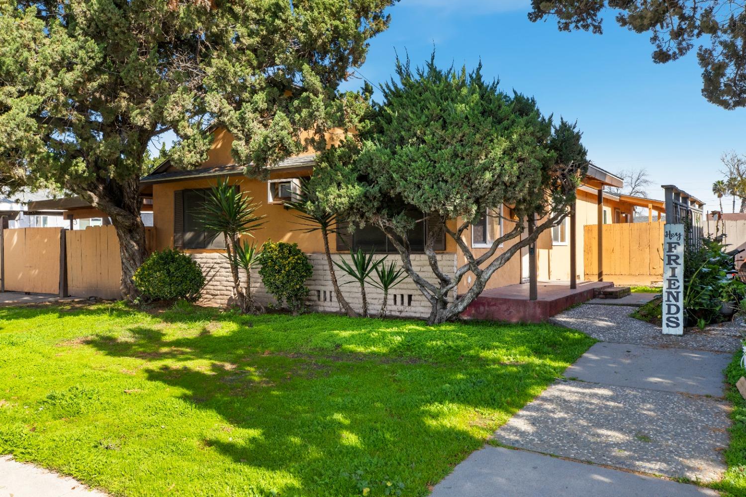 913 Colorado Avenue Modesto, CA 95351 - Photo 1 of 1 a yellow house with a tree in front of it
