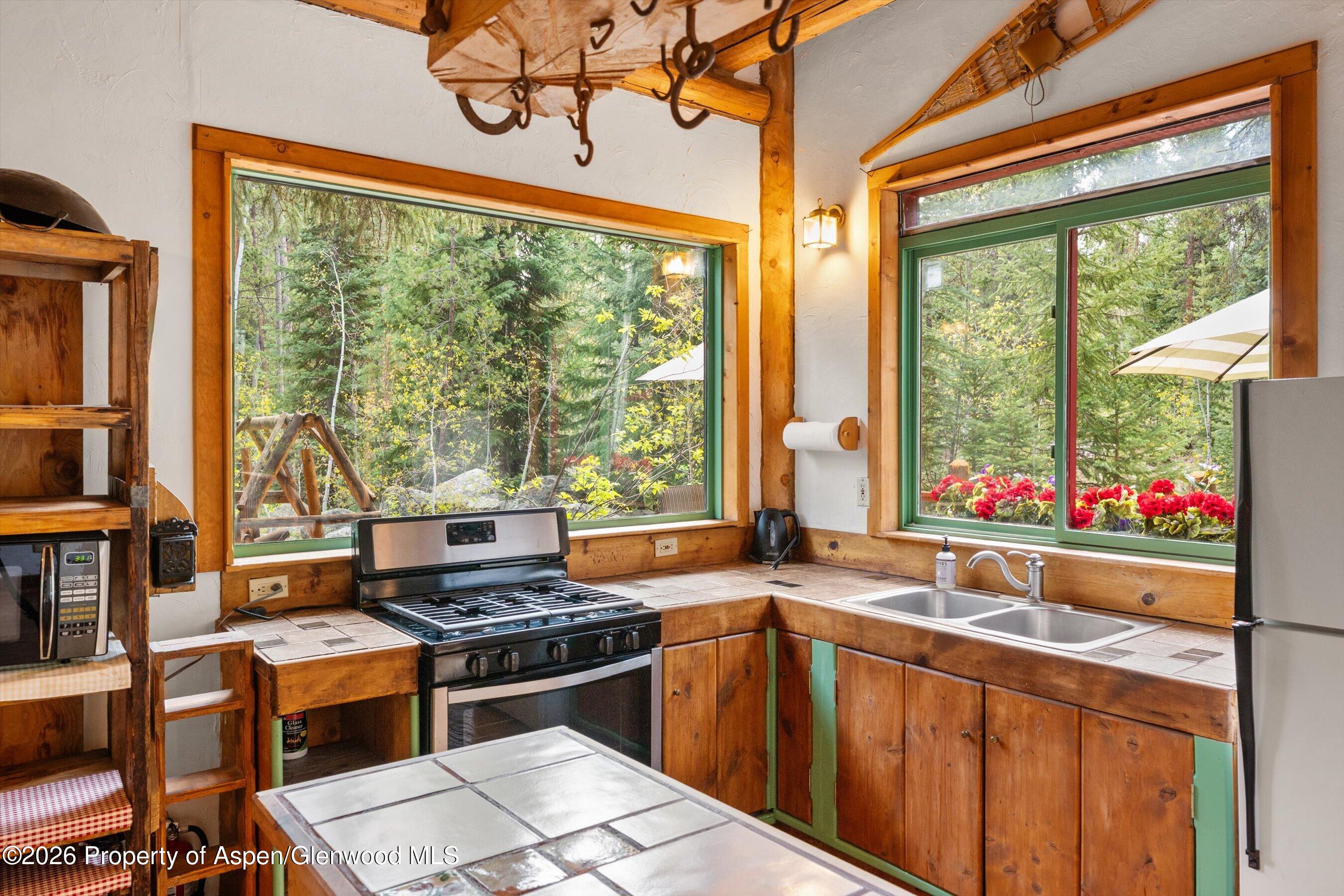 26608 Frying Pan Road Meredith, CO 81642 - Photo 20 of 49 a kitchen with a large window and a sink