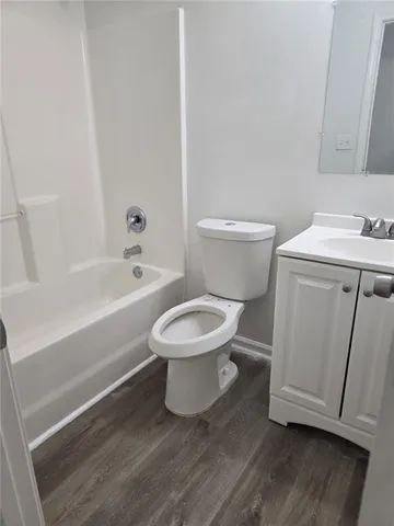 a white toilet sitting next to a bathroom sink