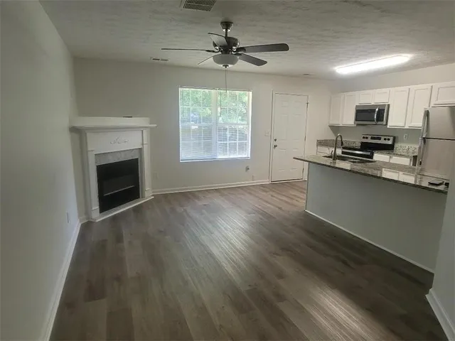 a view of a kitchen with microwave and cabinets