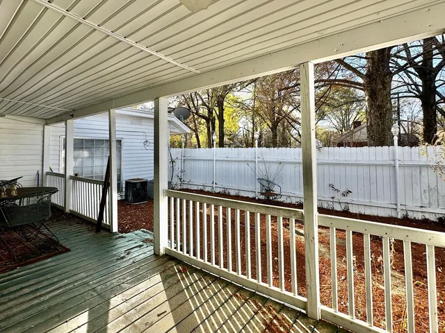 a view of a yard with wooden fence