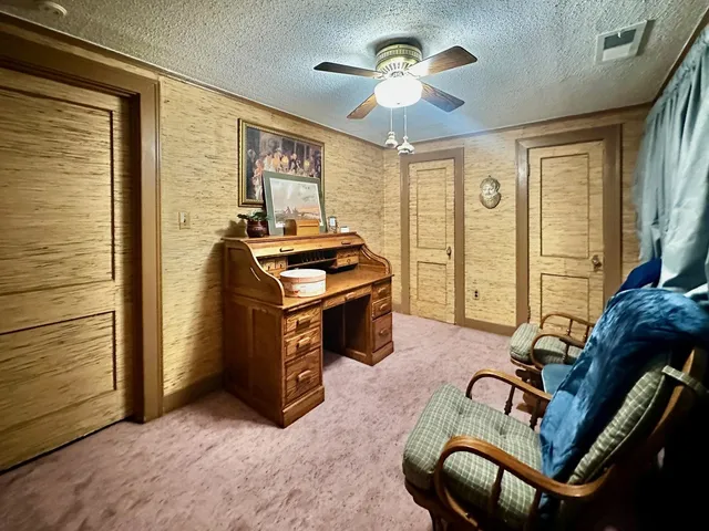 a living room with furniture gym equipment and a large window