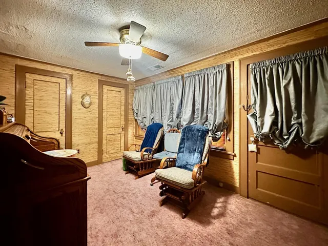 a view of a house with a small yard and plants