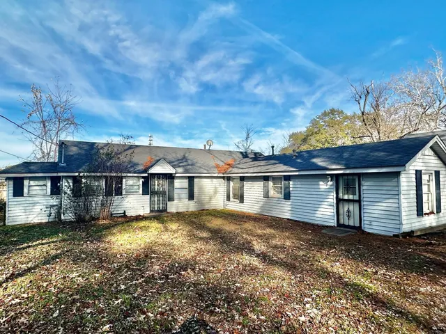 a view of house with yard and garage