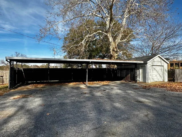 a view of a house with pool and a yard