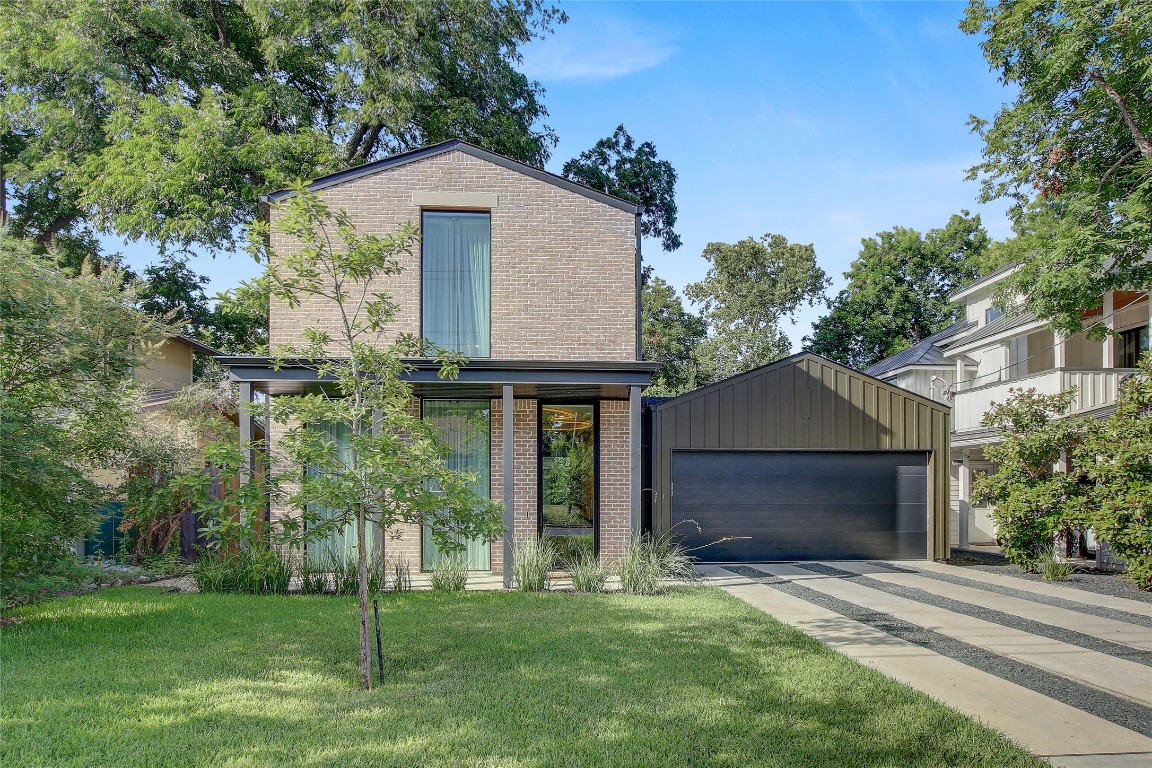 View of front facade featuring brick siding and a front lawn