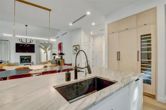 a kitchen with stainless steel appliances granite countertop a sink and a stove