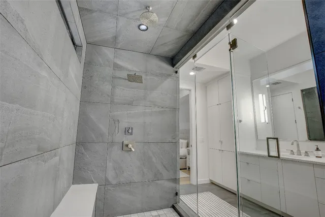 a bathroom with a shower and a sink