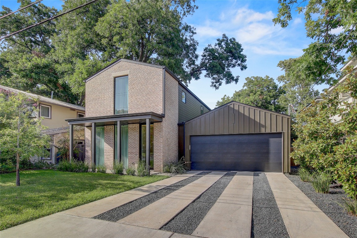 2006 Ford Street Austin, TX 78704 - Photo 2 of 40 View of front facade featuring brick siding and a front lawn