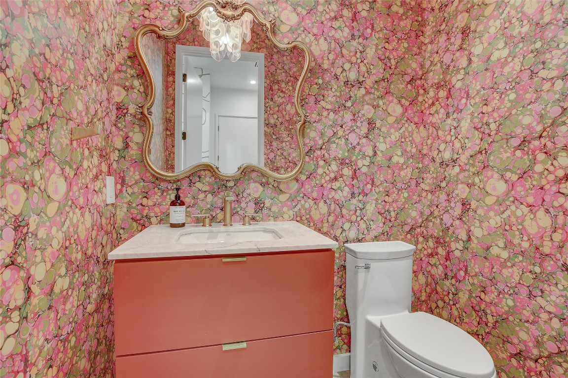 2006 Ford Street Austin, TX 78704 - Photo 25 of 40 Half bathroom with vanity and wallpapered walls on main floor