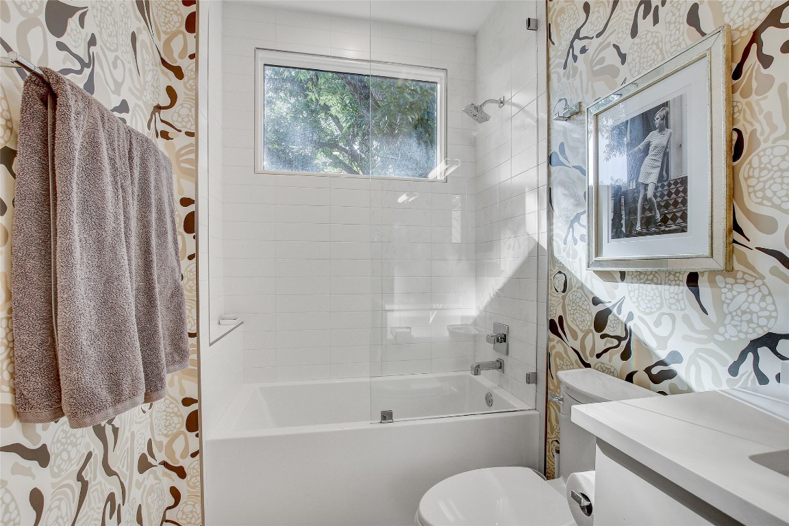 2006 Ford Street Austin, TX 78704 - Photo 33 of 40 Full bathroom on second floor featuring wallpapered walls, shower combination, and vanity