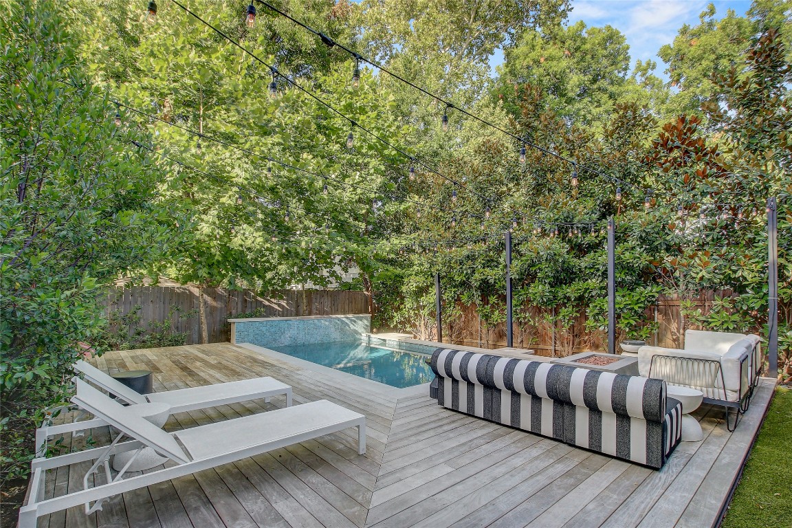 2006 Ford Street Austin, TX 78704 - Photo 40 of 40 Wooden terrace featuring a fenced backyard lined with trees