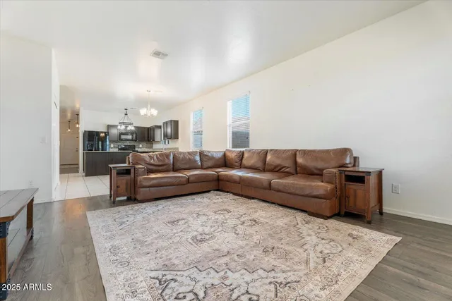 a living room with a couch and a dresser next to a window