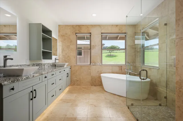 a spacious bathroom with a double vanity sink a mirror and a bathtub