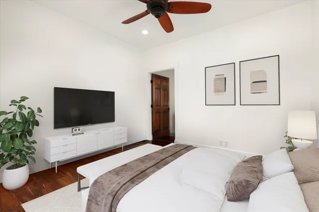 a bedroom with a bed and a flat screen tv