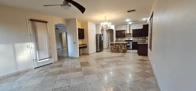 a view of a kitchen with a sink and a refrigerator